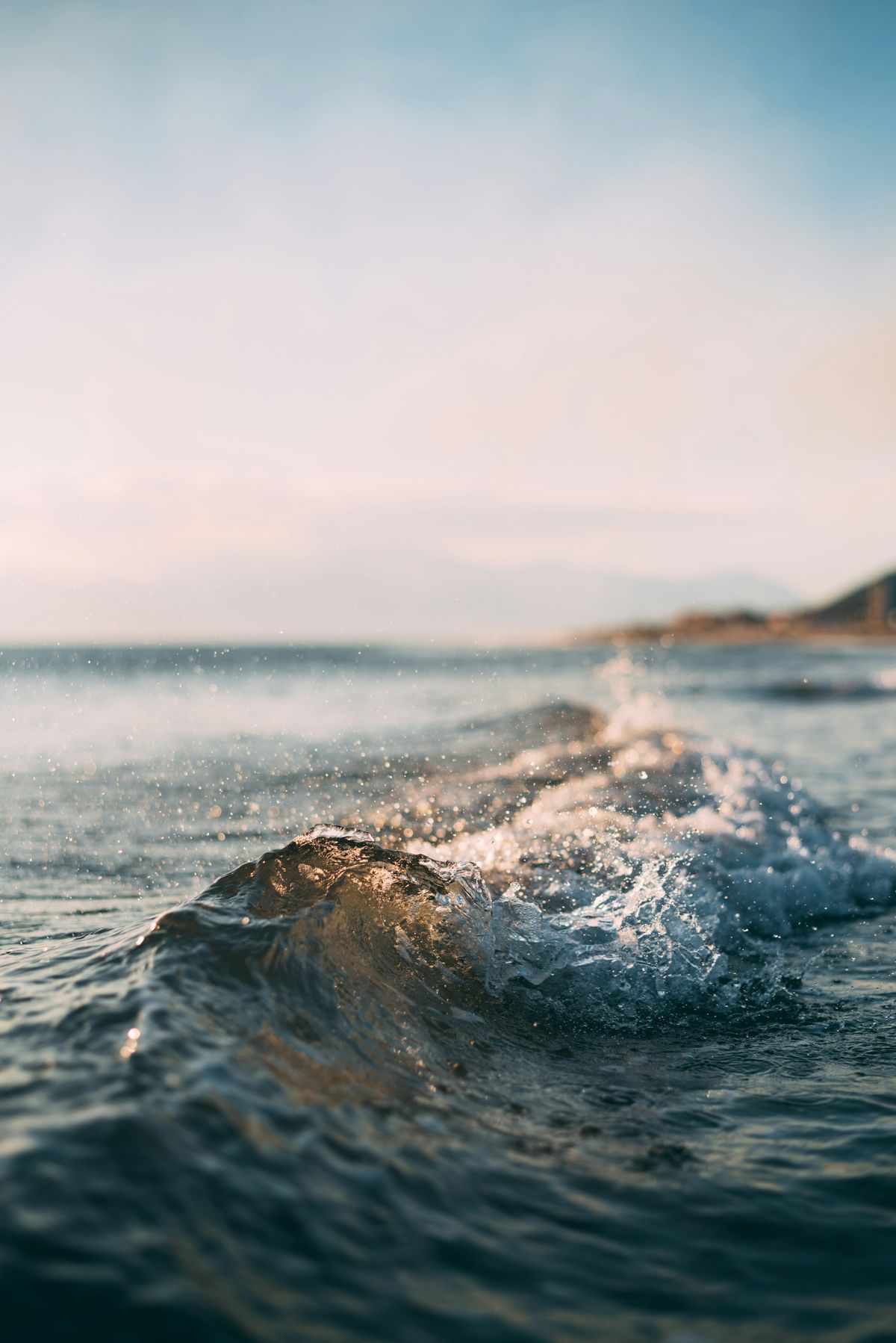 Sunlit waves breaking on the shore